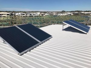Solar hot water systems panels on a metal roof in Bribie Island