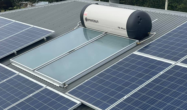 Solar hot water system on a metal roof with PV panels in Bribie Island